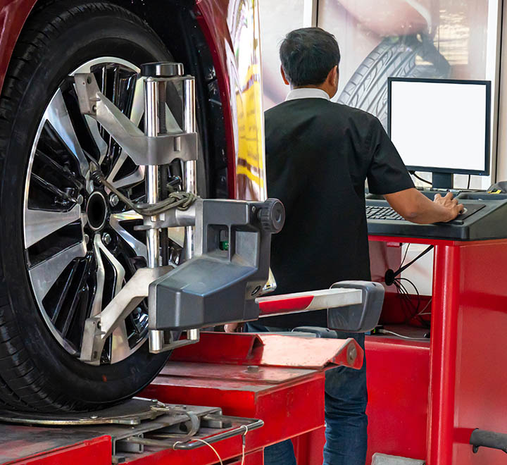 Wheel alignment ,Car on stand with sensors on wheels for wheels alignment camber check in workshop of Service station.